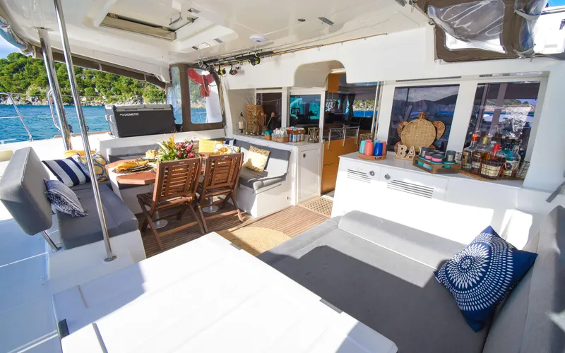 Slide: The Image of Luxurious 2015 Lagoon 450F yacht interior with dining area and scenic ocean view. - 24