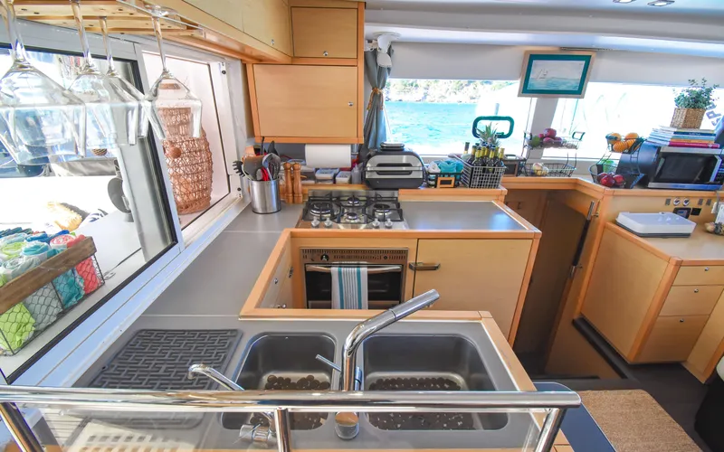 Slide: The Image of Interior of 2015 Lagoon 450F yacht kitchen with modern amenities and ocean view. - 31