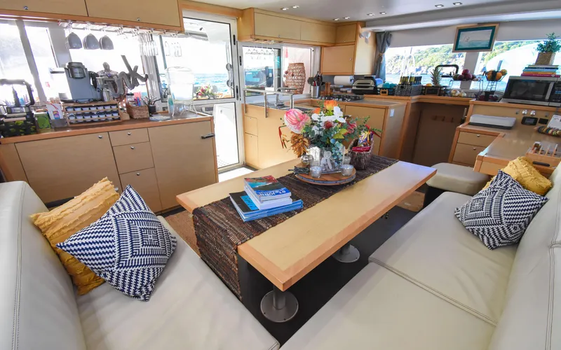 Slide: The Image of Interior of 2015 Lagoon 450F yacht, featuring a cozy seating area and modern kitchen. - 33