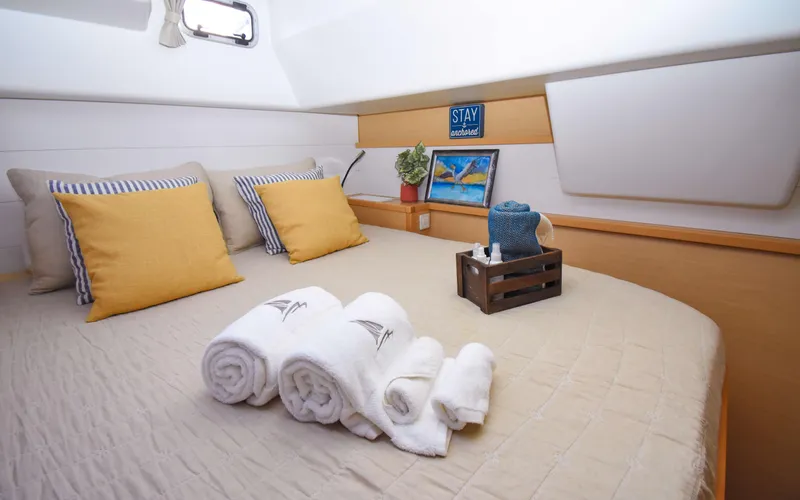 Slide: The Image of Cozy cabin interior of 2015 Lagoon 450F with neatly arranged towels and decorative pillows. - 34