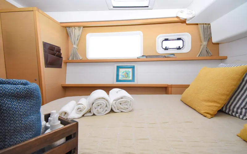 Slide: The Image of Cozy cabin interior of 2015 Lagoon 450F yacht with neatly arranged towels and pillows. - 35