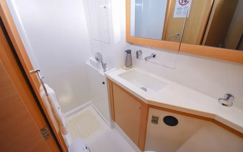 Slide: The Image of 2015 Lagoon 450F yacht bathroom with modern sink, mirror, and shower area. - 36