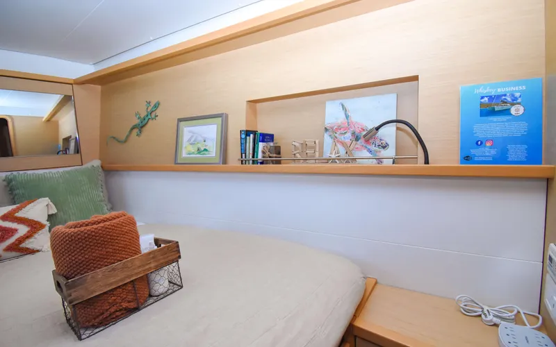 Slide: The Image of Cozy cabin interior of 2015 Lagoon 450F yacht with decorative accents and shelving. - 45