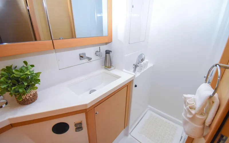 Slide: The Image of Modern bathroom in 2015 Lagoon 450F yacht with sink, mirror, and shower. - 46