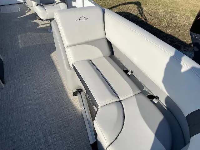 Slide: The Image of 2025 SunCatcher Select 20RC boat interior with gray seating and carpeted flooring. - 13