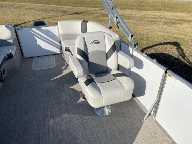 Slide: The Image of 2025 SunCatcher Select 20RC boat seat, gray and white upholstery, outdoor setting. - 16