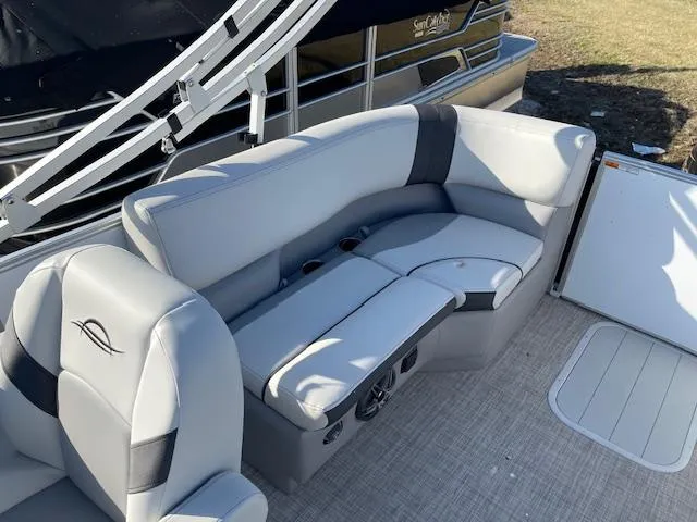 Slide: The Image of 2025 SunCatcher Select 20RC boat interior with gray seating and cup holders. - 18