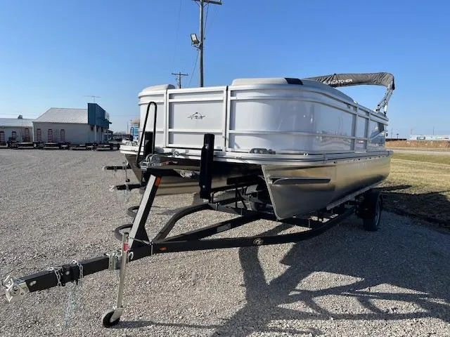 Slide: The Image of 2025 SunCatcher Select 20RC pontoon boat on trailer in outdoor setting. - 2