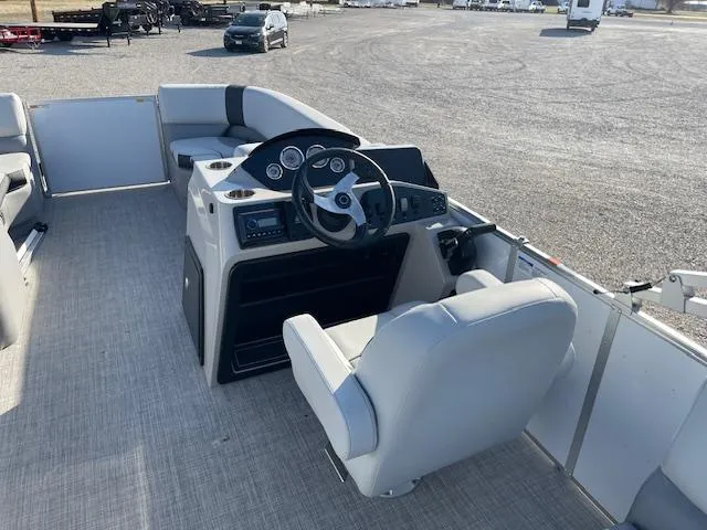 Slide: The Image of 2025 SunCatcher Select 20RC pontoon boat interior with steering console and seating. - 20