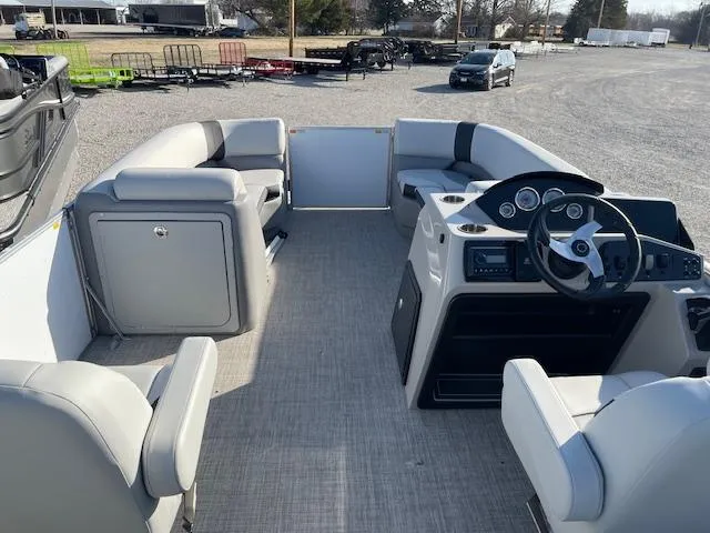 Slide: The Image of 2025 SunCatcher Select 20RC pontoon boat interior with seating and steering console. - 21