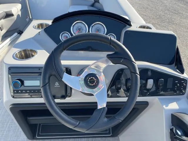 Slide: The Image of Steering console of 2025 SunCatcher Select 20RC boat with gauges and controls. - 24