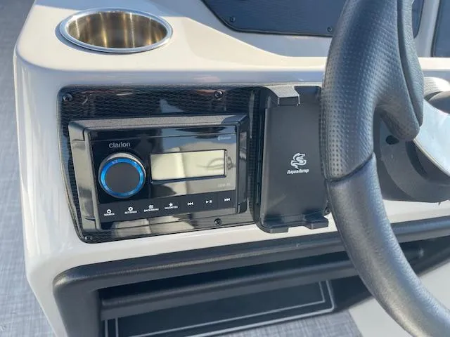 Slide: The Image of 2025 SunCatcher Select 20RC dashboard with Clarion stereo and steering wheel. - 25