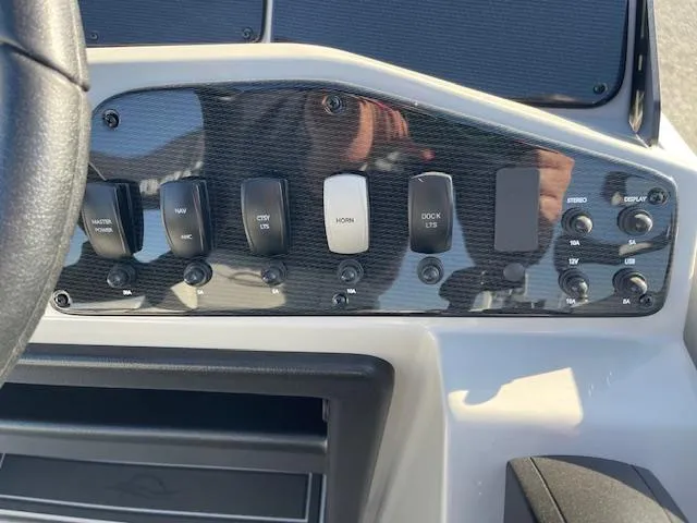 Slide: The Image of Dashboard controls of 2025 SunCatcher Select 20RC boat, featuring various switches and buttons. - 26