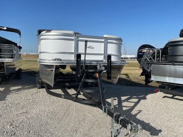 Slide: The Image of 2025 SunCatcher Select 20RC pontoon boat on trailer, parked outdoors. - 8