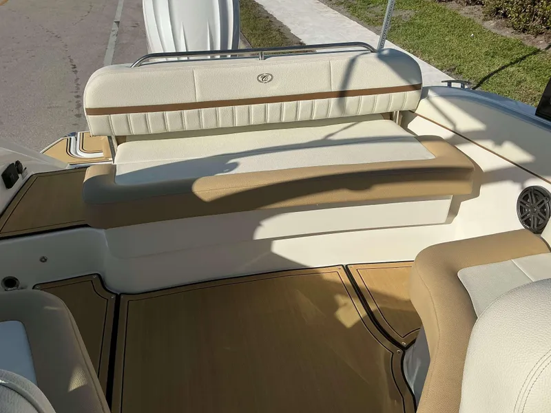 Slide: The Image of 2022 Cobalt 23 SC boat interior with beige seating and wood accents. - 16