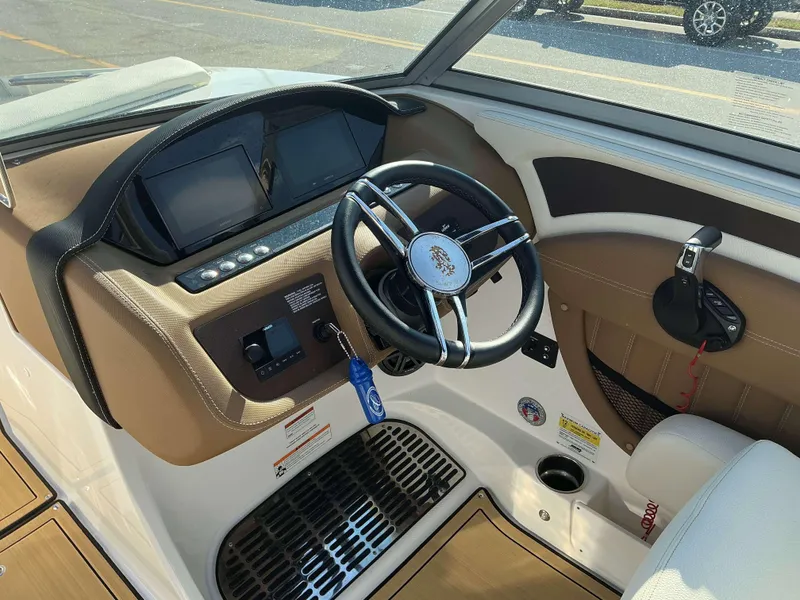 Slide: The Image of Interior view of 2022 Cobalt 23 SC boat dashboard and steering wheel. - 18