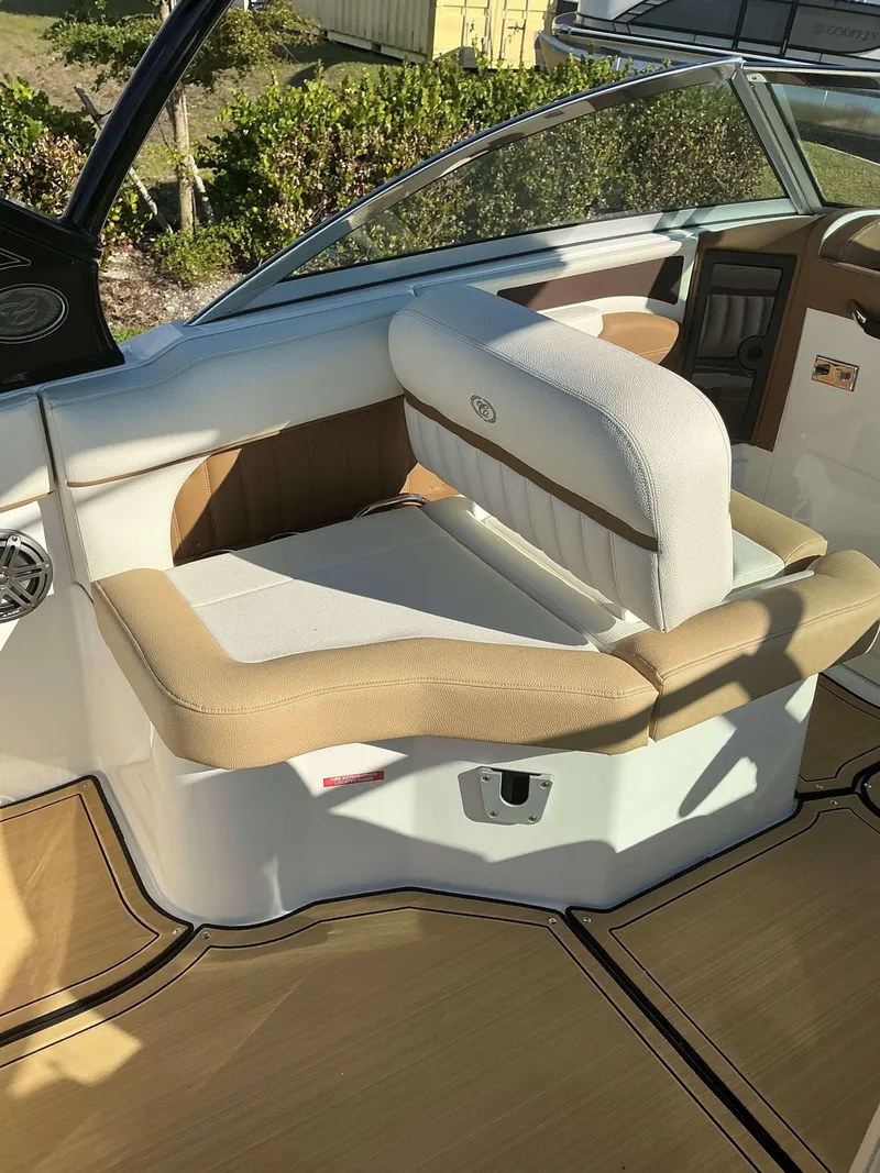 Slide: The Image of 2022 Cobalt 23 SC boat interior with beige and white seating. - 19