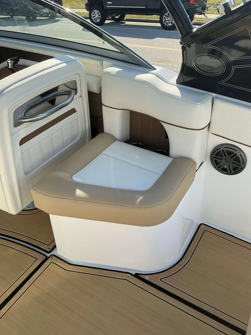 Slide: The Image of 2022 Cobalt 23 SC boat interior with tan and white seating. - 20