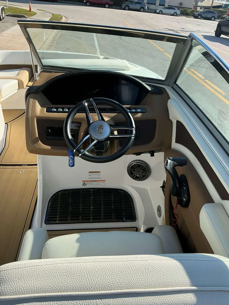 Slide: The Image of 2022 Cobalt 23 SC boat cockpit with steering wheel and dashboard controls. - 21