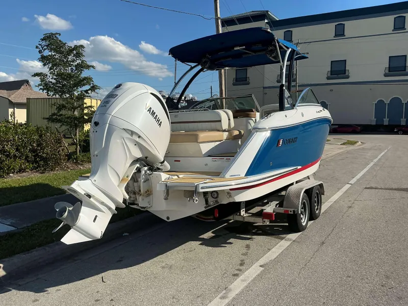 Slide: The Image of 2022 Cobalt 23 SC boat on trailer with Yamaha outboard motor, parked on street. - 3