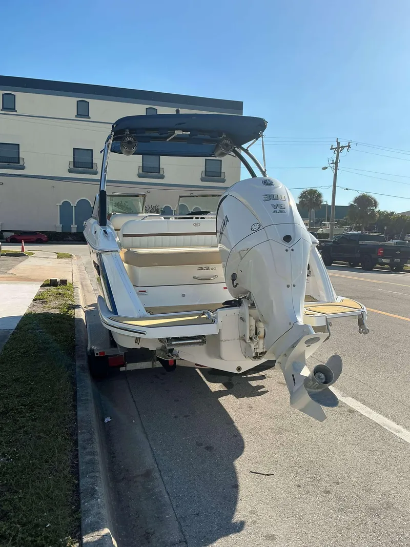 Slide: The Image of 2022 Cobalt 23 SC boat with Yamaha outboard motor parked on street. - 4