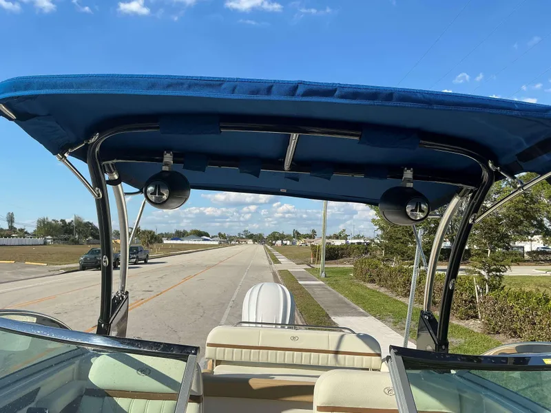 Slide: The Image of 2022 Cobalt 23 SC boat with blue canopy on a sunny day. - 6