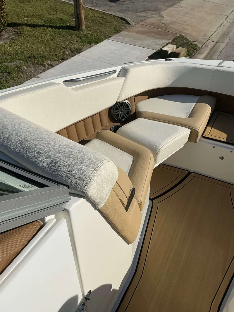 Slide: The Image of 2022 Cobalt 23 SC boat interior with beige and white seating. - 8