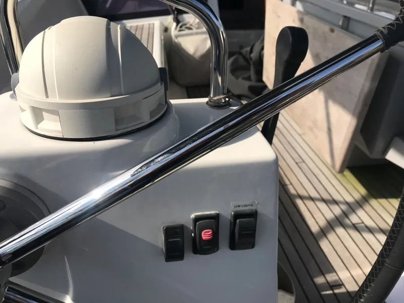 Slide: The Image of Control panel of a 2014 Beneteau Oceanis 48 yacht with switches and steering wheel. - 18