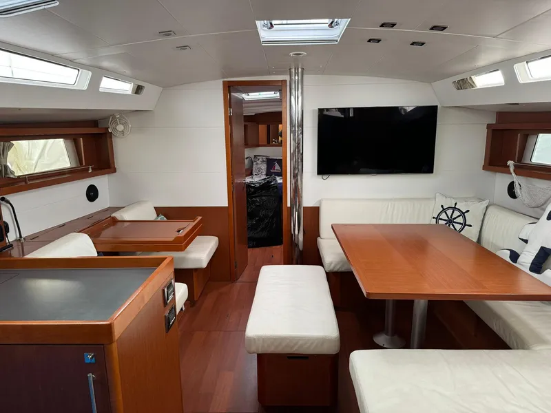 Slide: The Image of Interior of a 2014 Beneteau Oceanis 48 yacht with modern furnishings and a spacious layout. - 24