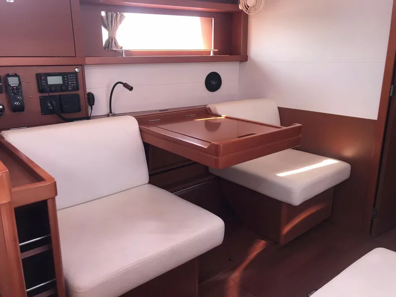 Slide: The Image of Interior of 2014 Beneteau Oceanis 48 yacht with seating and navigation equipment. - 26