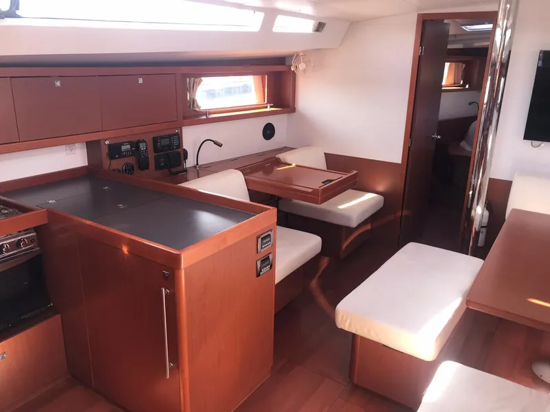 Slide: The Image of Interior of 2014 Beneteau Oceanis 48 yacht, featuring modern kitchen and seating area. - 27