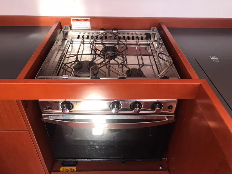 Slide: The Image of Beneteau Oceanis 48 (2014) yacht kitchen stove with four burners and oven. - 31