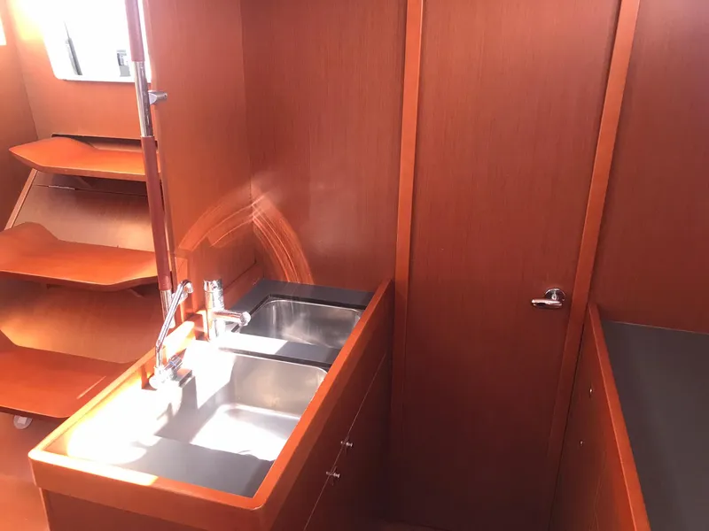 Slide: The Image of Interior of 2014 Beneteau Oceanis 48 yacht with wooden cabinetry and dual sinks. - 33
