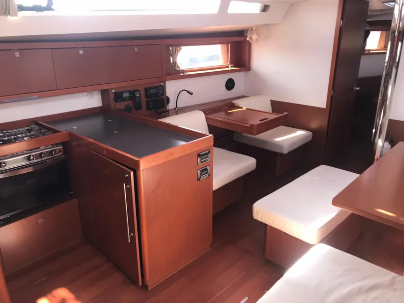 Slide: The Image of Interior of 2014 Beneteau Oceanis 48 yacht with kitchen and dining area. - 37