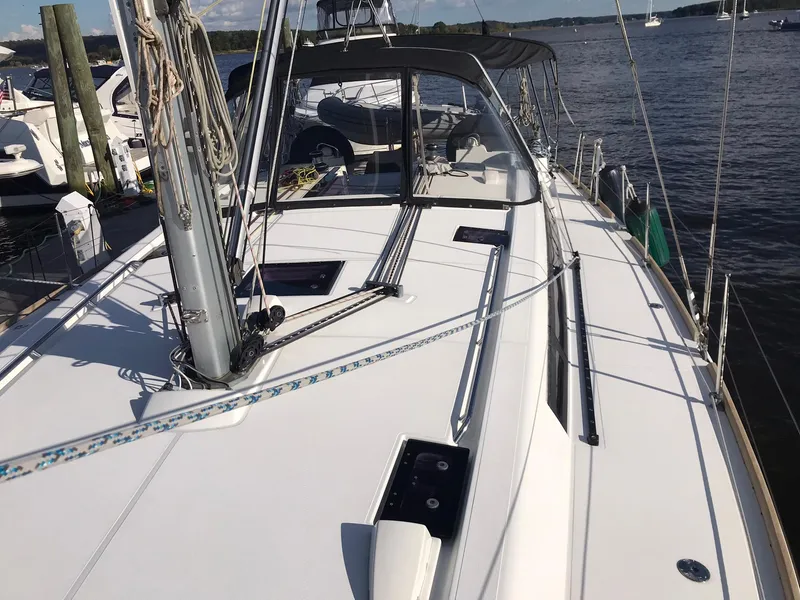 Slide: The Image of 2014 Beneteau Oceanis 48 sailboat docked, showcasing sleek deck design and rigging. - 4