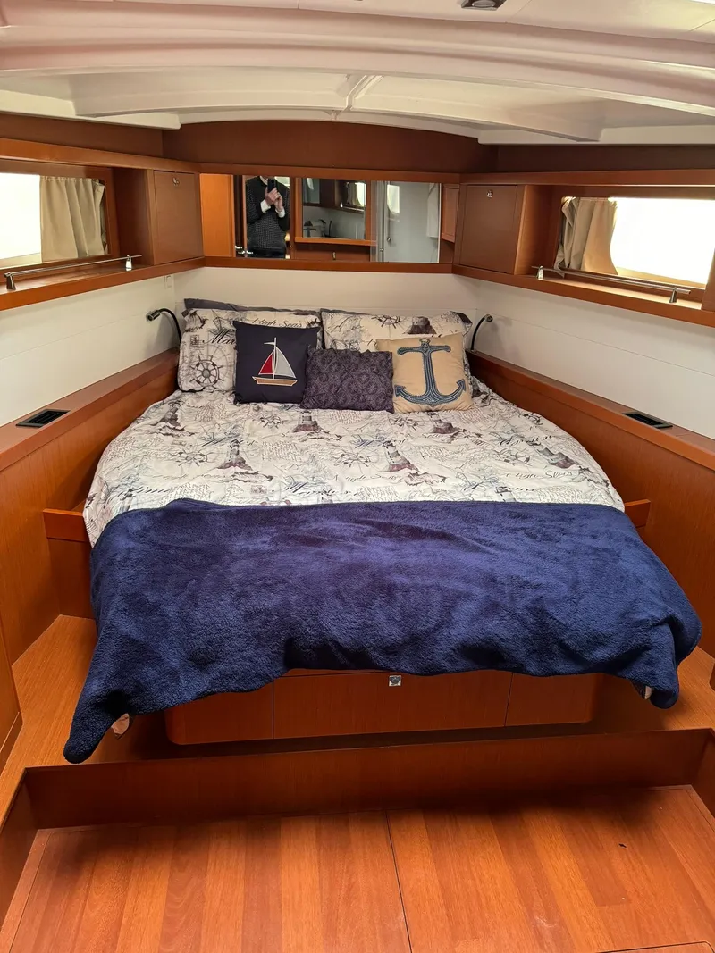 Slide: The Image of Cozy cabin interior of 2014 Beneteau Oceanis 48 yacht with nautical-themed bedding. - 41