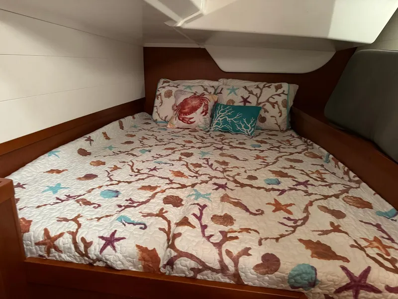 Slide: The Image of Cozy cabin bed in 2014 Beneteau Oceanis 48 with nautical-themed bedding. - 46