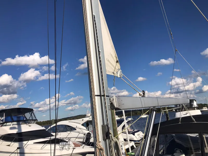 Slide: The Image of Beneteau Oceanis 48 sailboat, 2014 model, docked under a clear blue sky. - 8
