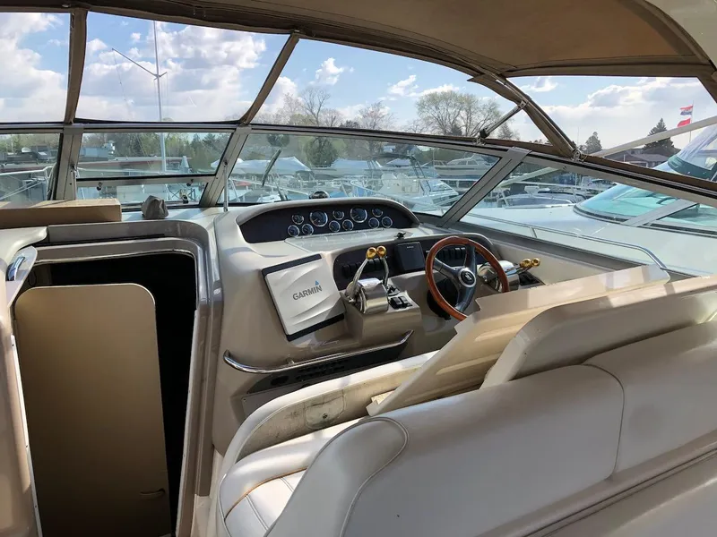 Slide: The Image of Interior view of 1998 Sea Ray 330 Sundancer boat cockpit with steering wheel and navigation equipment. - 9