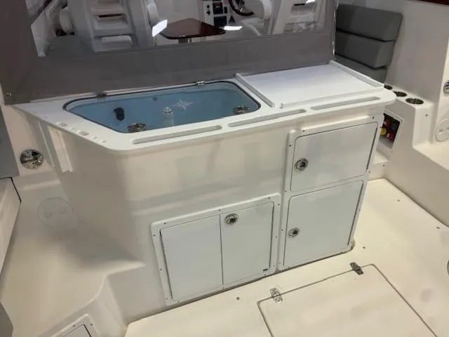 Slide: The Image of 2025 NorthCoast 285 HT boat interior with storage compartments and seating area. - 12