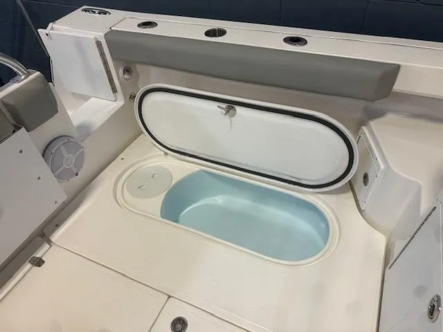 Slide: The Image of 2025 NorthCoast 285 HT boat interior with open storage compartment. - 14