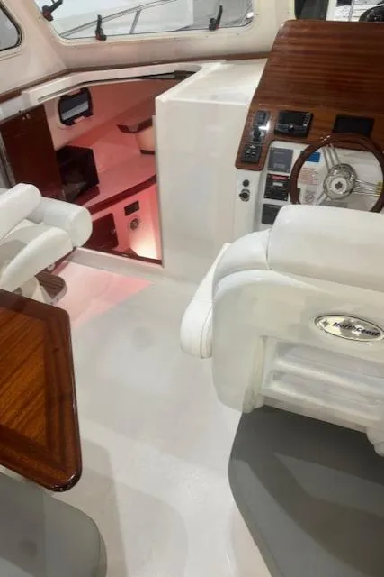 Slide: The Image of Interior of 2025 NorthCoast 285 HT boat with modern helm and seating. - 20