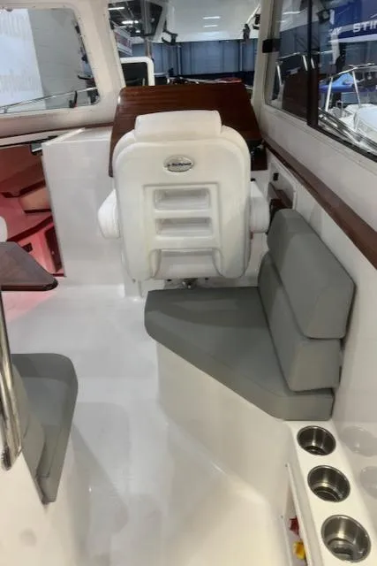 Slide: The Image of Interior of 2025 NorthCoast 285 HT boat with seating and helm station. - 21