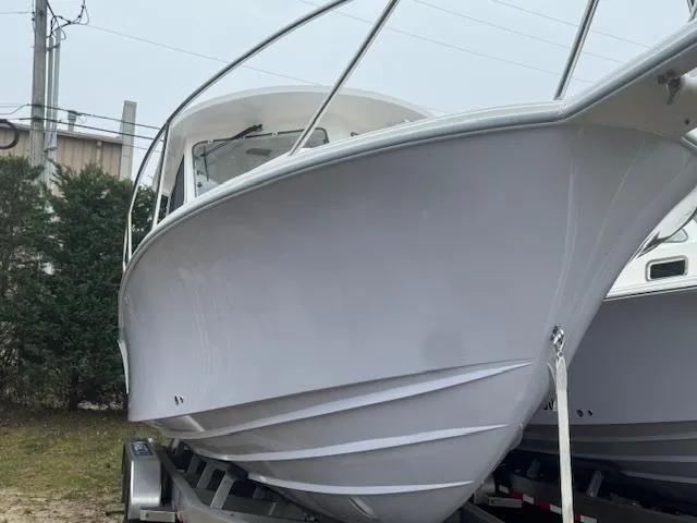 Slide: The Image of 2025 NorthCoast 285 HT boat on trailer, showcasing sleek design and sturdy build. - 9