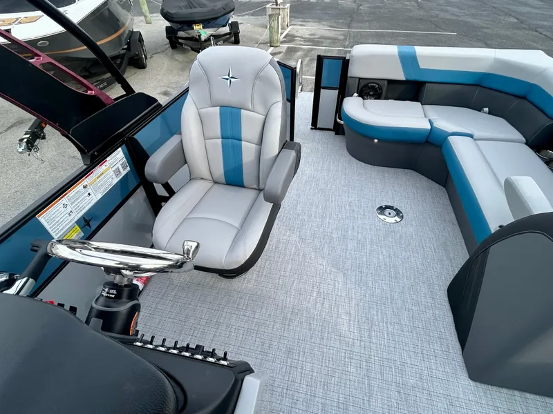 Slide: The Image of 2025 Berkshire 22CL2 ARCH CTS 2.75 boat interior with plush seating and steering wheel. - 14