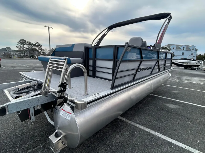 Slide: The Image of 2025 Berkshire 22CL2 ARCH CTS pontoon boat parked in a lot under cloudy skies. - 5