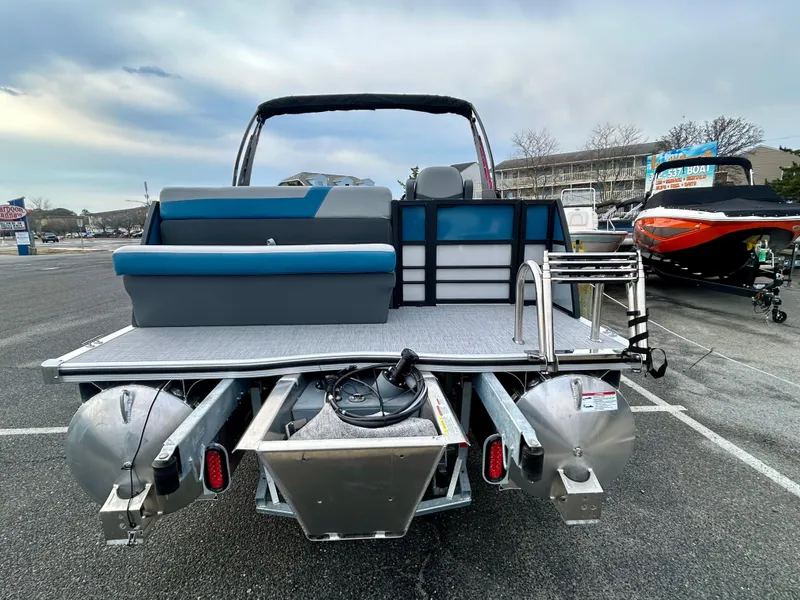 Slide: The Image of 2025 Berkshire 22CL2 ARCH CTS 2.75 pontoon boat, rear view, in a parking lot. - 6