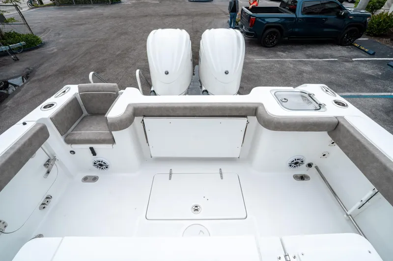 Slide: The Image of 2025 Sea Hunt Gamefish 28 CB boat interior with seating and dual engines. - 10