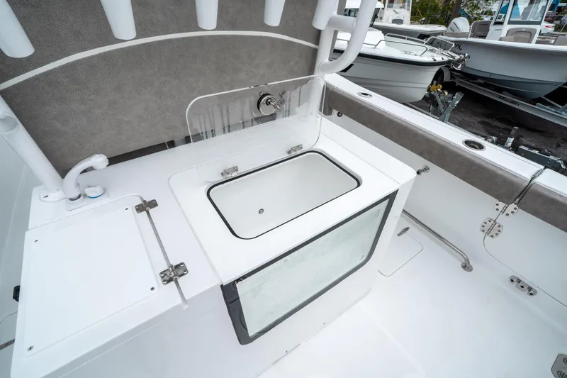 Slide: The Image of 2025 Sea Hunt Gamefish 28 CB boat interior with livewell and storage compartments. - 16