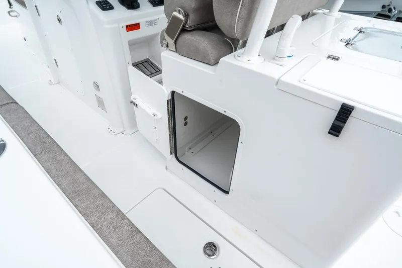 Slide: The Image of 2025 Sea Hunt Gamefish 28 CB interior storage compartment and seating area. - 18